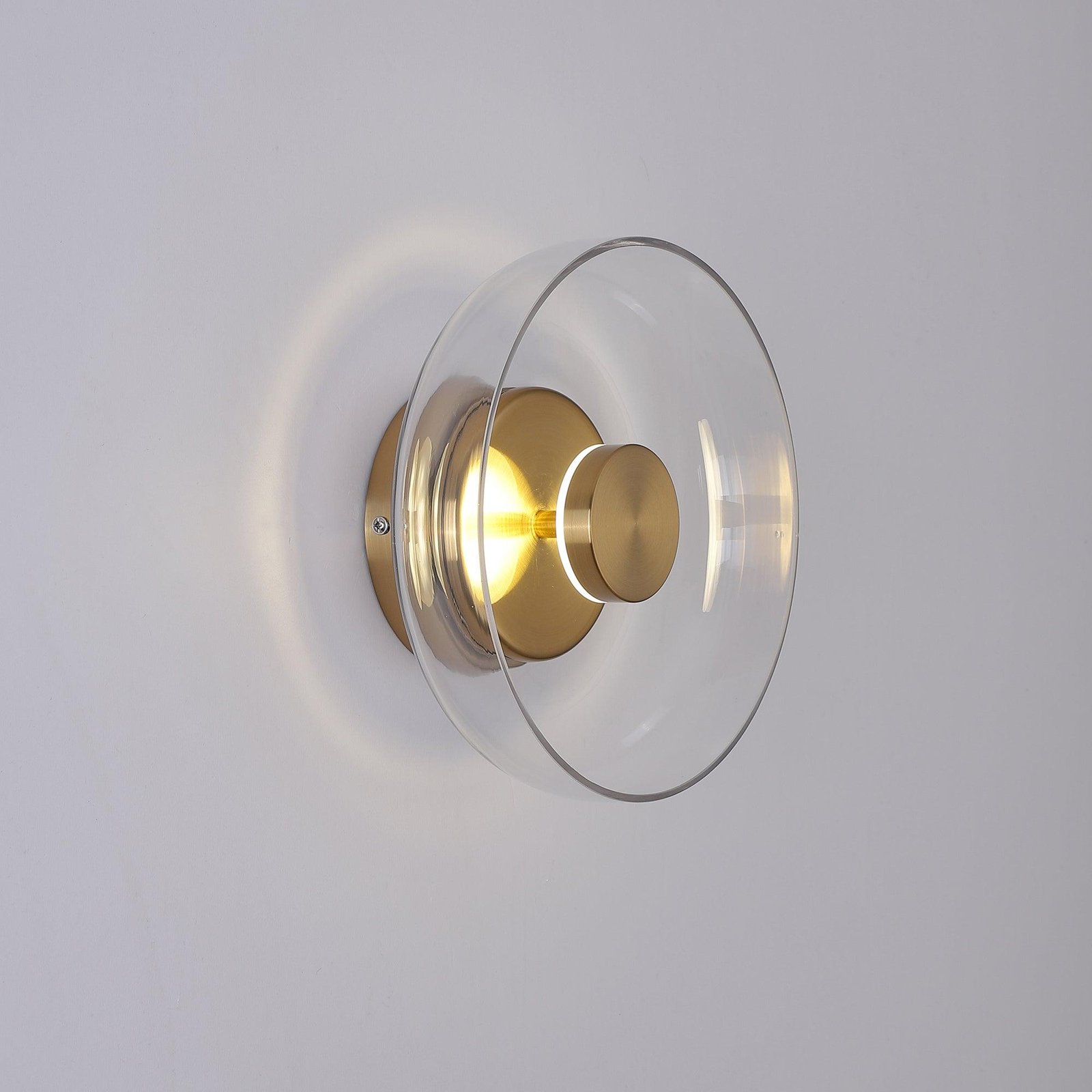Blossi Wall Light with a Diameter of 3.9 Inches and Height of 9 Inches, or 10cm x 23cm, emits a Cool White Light and features a Brass Finish with Clear Glass